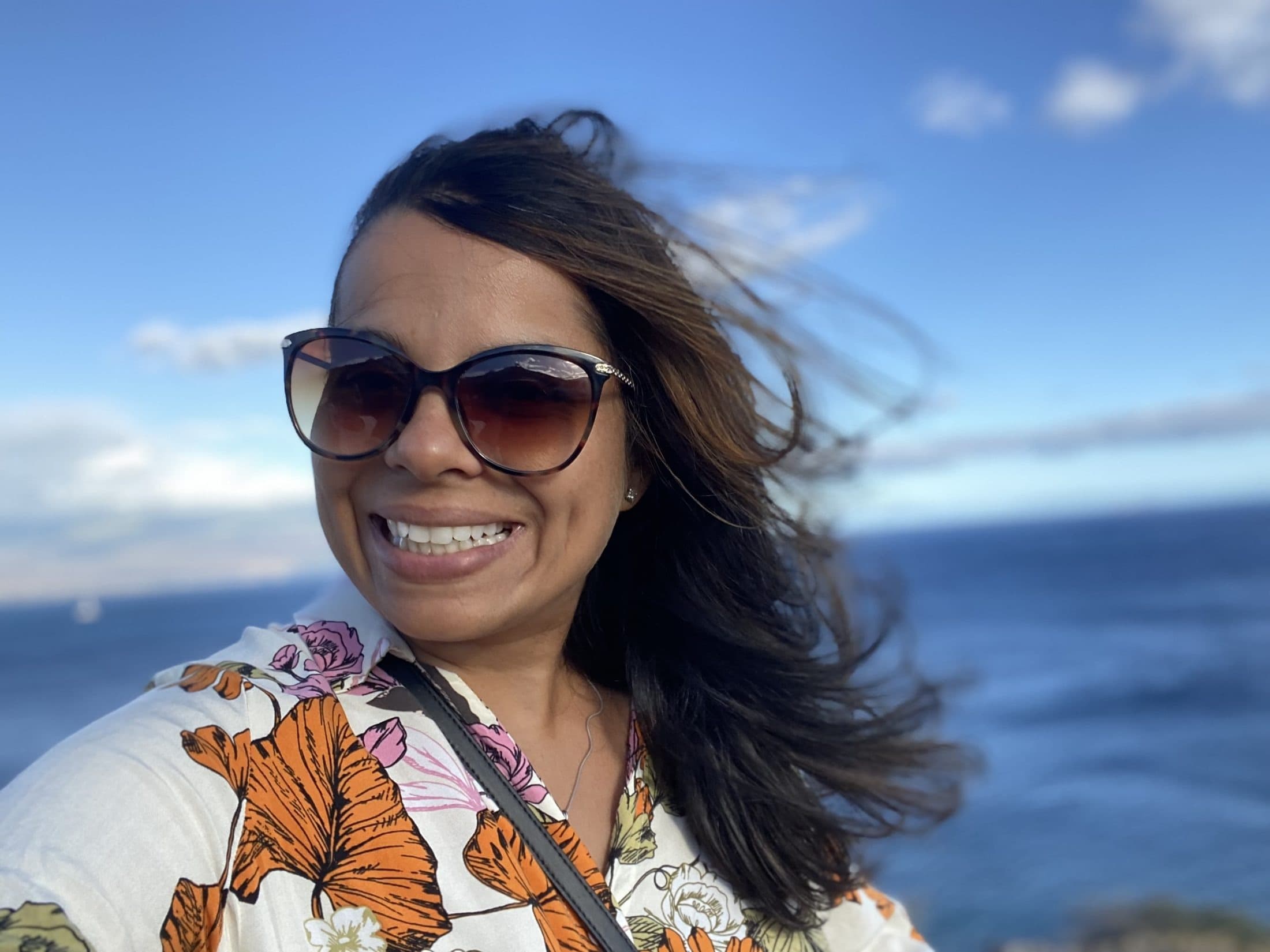 Mamata smiling by the ocean