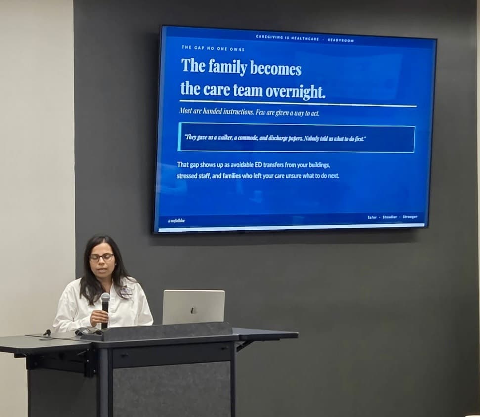 Dr. Mamata Majmundar delivering this talk, beside a slide reading “The family becomes the care team overnight”